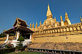 Vientiane, Laos - Surrounded by a cluster of pointed minor stupas the huge Pha That Luang shined under the warm light of the sunset. 